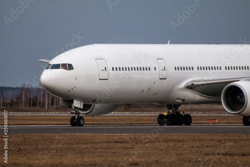 Close-up taxiing white wide body passenger airplane