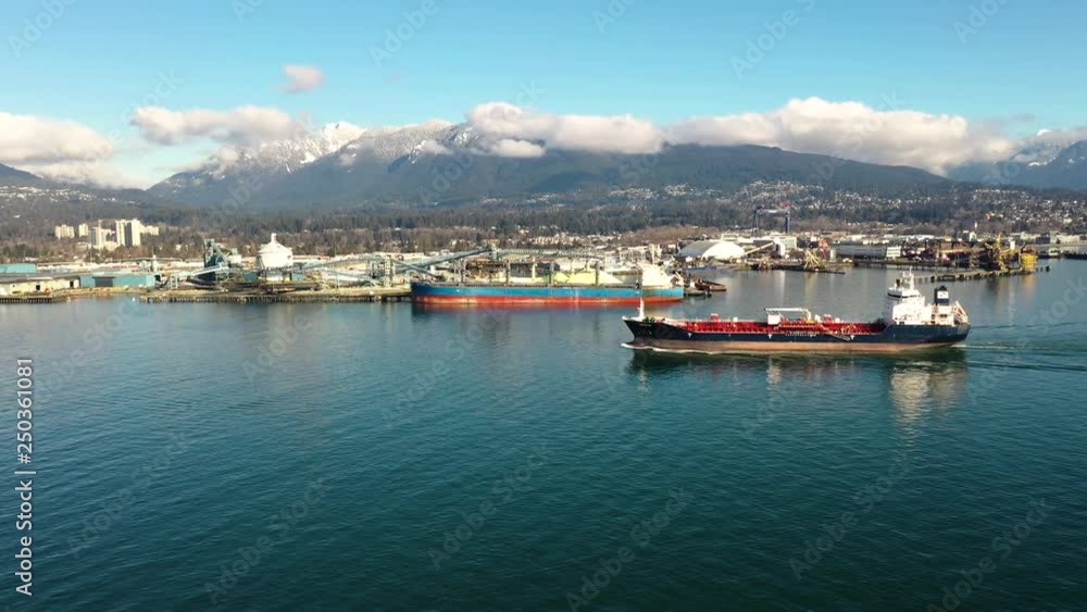Aerial view of a container ship sailing out of a harbor Aerial view of a container ship sailing out of a harbor