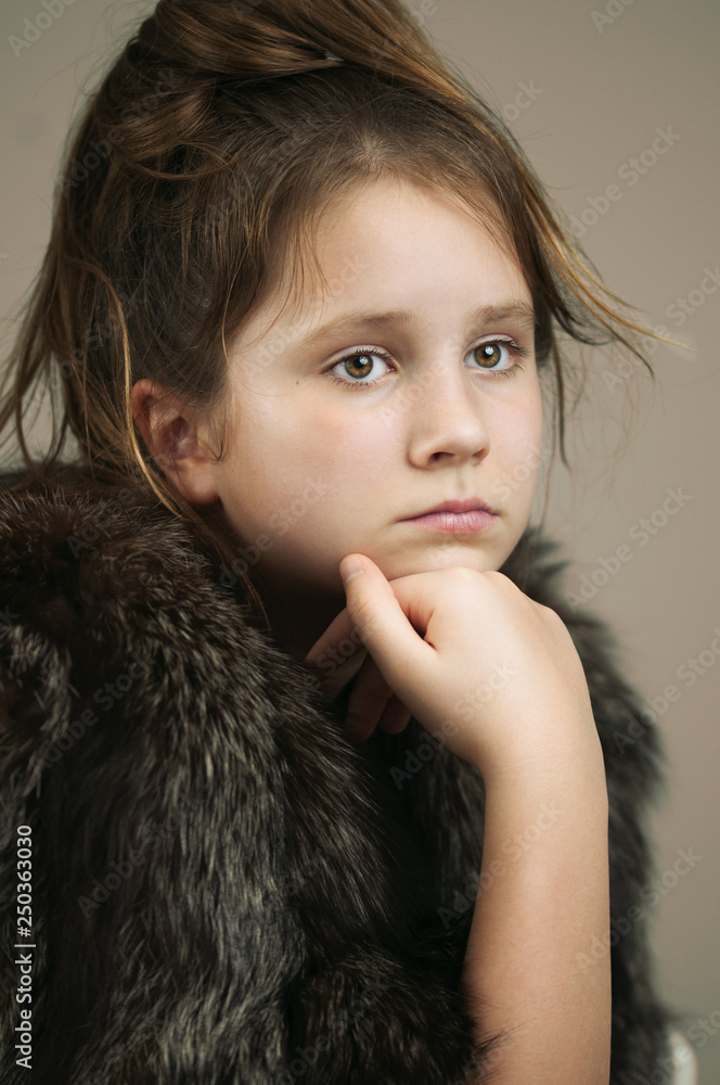 A portrait of a girl in a fur coat