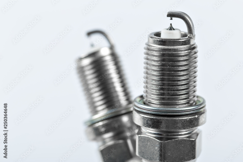 spark plugs on white background, shallow depth of field spark plugs on white background, shallow depth of field