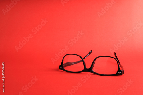 Glasses on red background