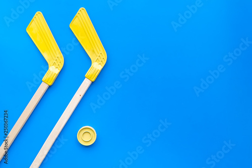 Ice hockey stick and puck on blue background top view space for text photo