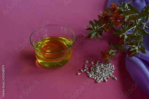 Canvas-taulu Safflower oil, seeds and stems with safflower flowers.