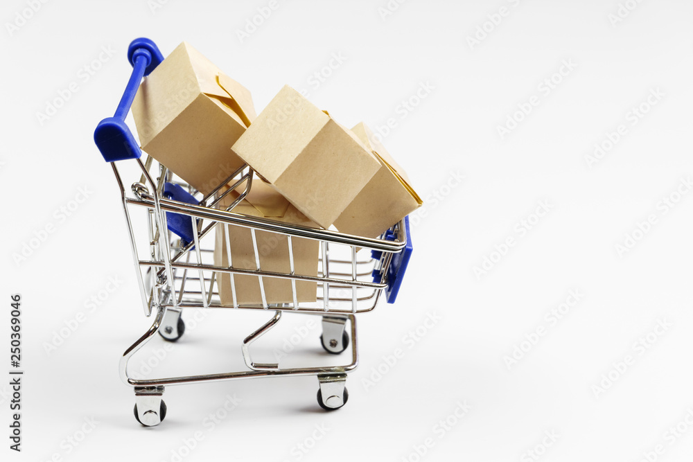 Supermarket cart with boxes on white background. The concept of delivery of goods, online shopping.