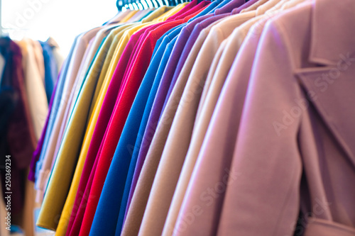 Multi-colored coat on a hanger in a clothing store Background