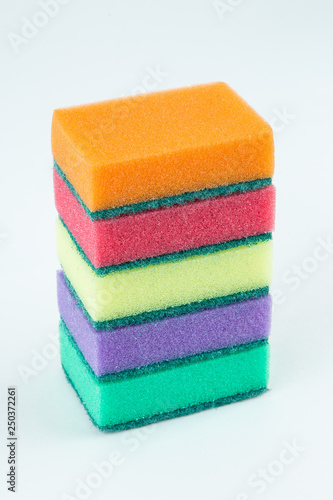Multicolored sponges for washing dishes on white isolated background. Selective focus.