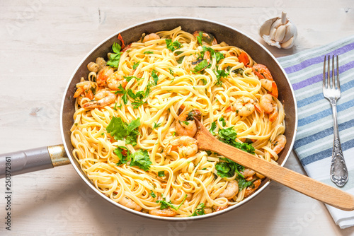 Linguine with shrimps in a frying pan - traditional Mediterranean pasta with seafood, Italian cuisine.