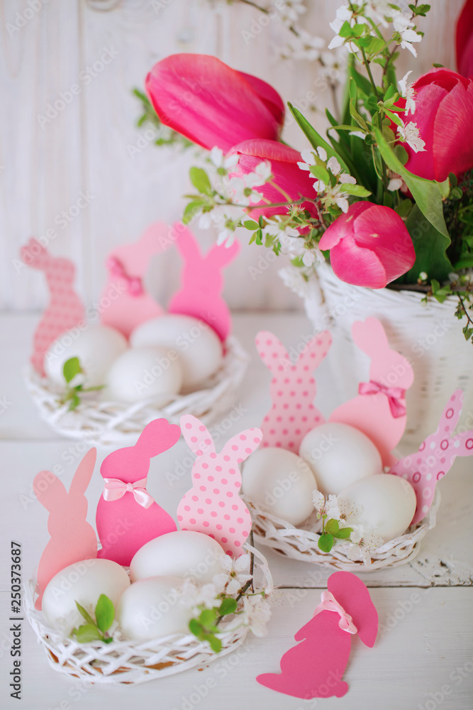 Happy easter. Decor of Easter eggs in the form of Easter bunnies in small white baskets. Happy easter. Decor of Easter eggs in the form of Easter bunnies in small white baskets.
