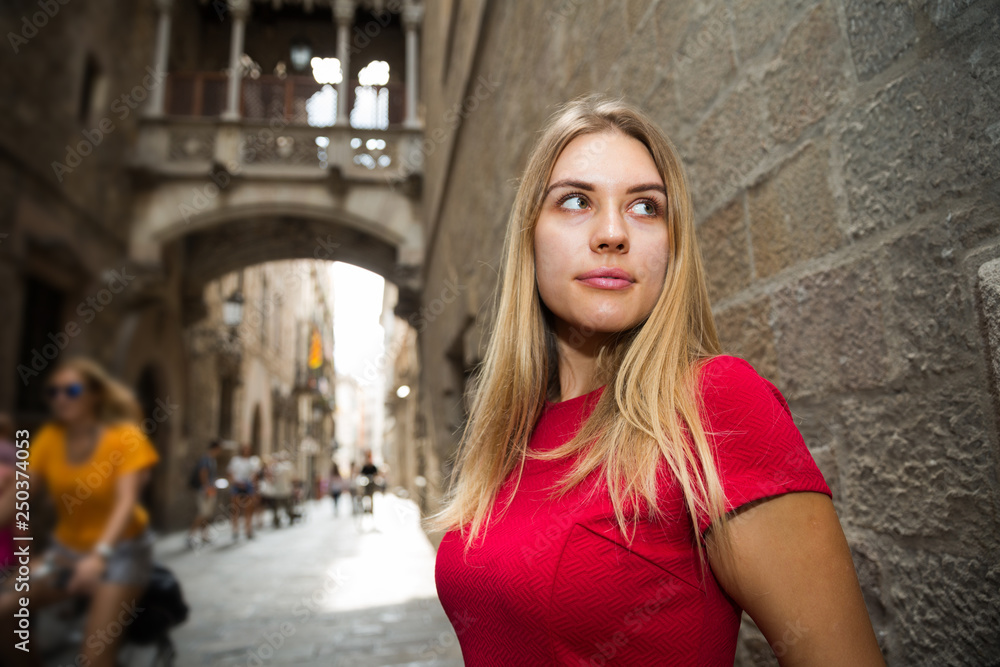 Fototapeta premium beautiful girl walks through the old European streets
