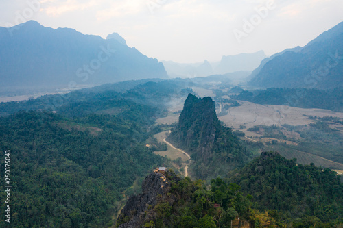 (View from above) Stunning aerial view of a beautiful little hut on top of the Pha Ngeum Viewpoint reachable by climbing a limestone mountain. Vang Vieng, Laos.