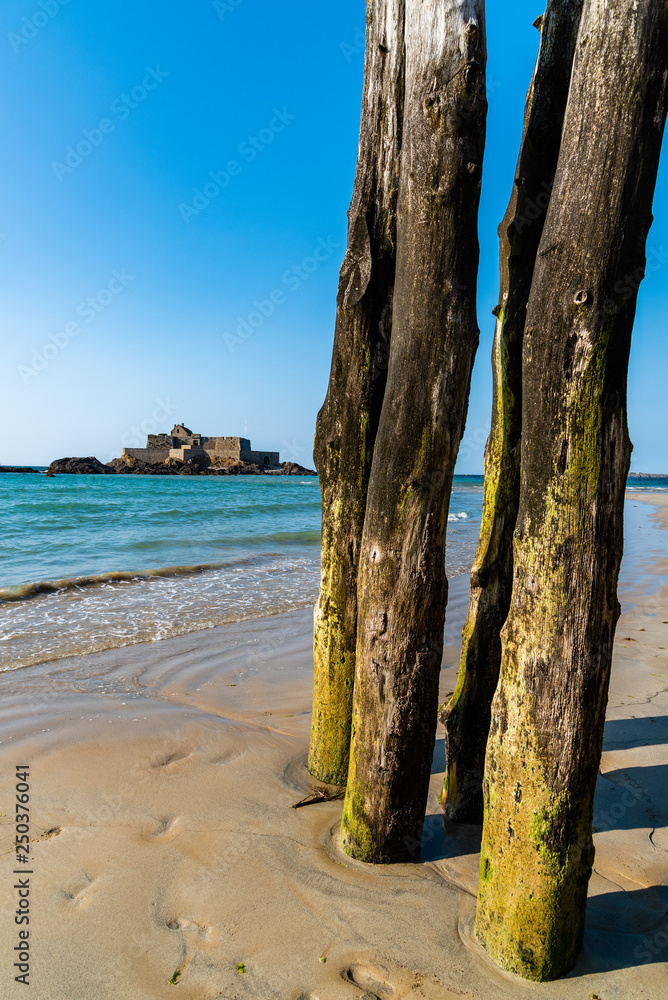 Wooden Poles outside Saint Malo walls at low tide Wooden Poles outside Saint Malo walls at low tide
