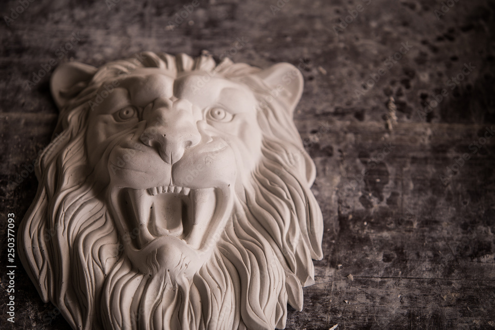 Creation of sculpture from plaster. Lion's head. Plaster workshop. Tooling.