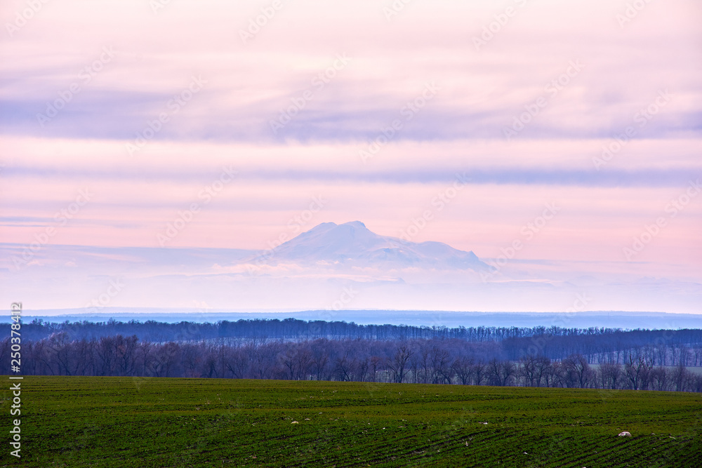 Naklejka premium Mountains and field