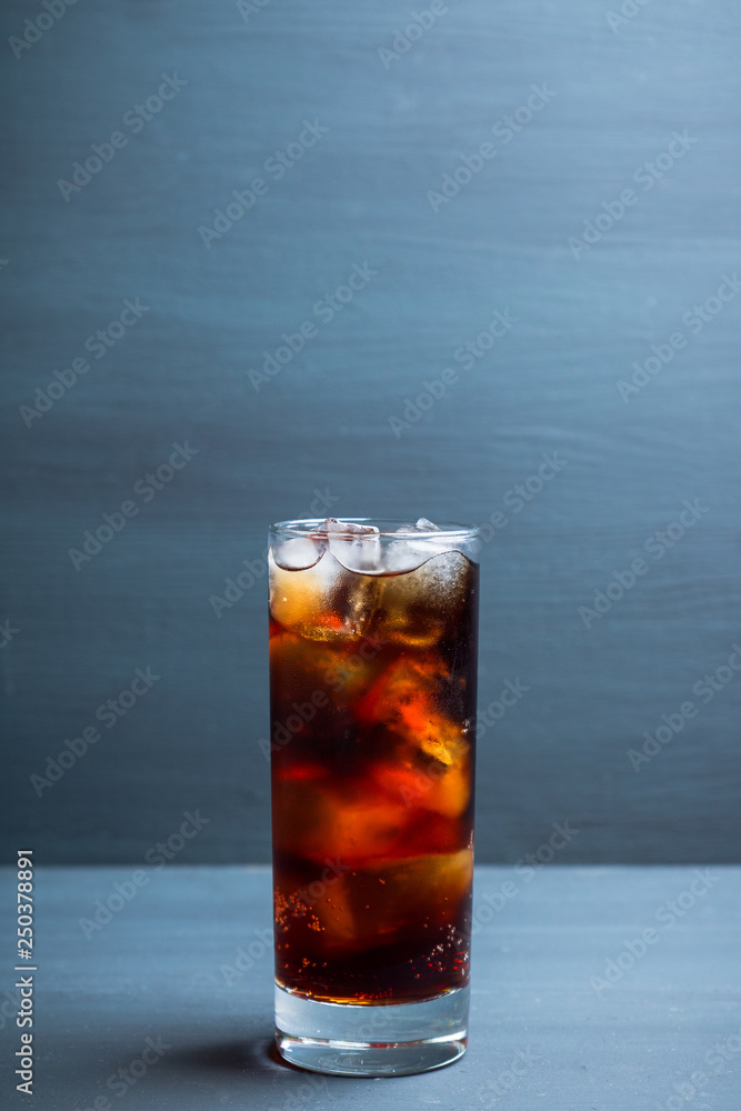 Cold cola beverage in glass with ice. Selective focus. Shallow depth of field. Cold cola beverage in glass with ice. Selective focus. Shallow depth of field.