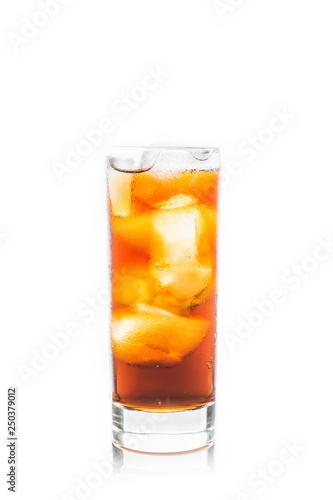 Cold cola beverage in glass with ice isolated on white background. Selective focus. Shallow depth of field.