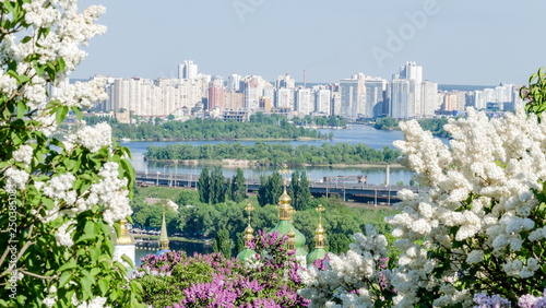 Orthodox church in the garden of blooming lilac Ukraine, Kiev photo