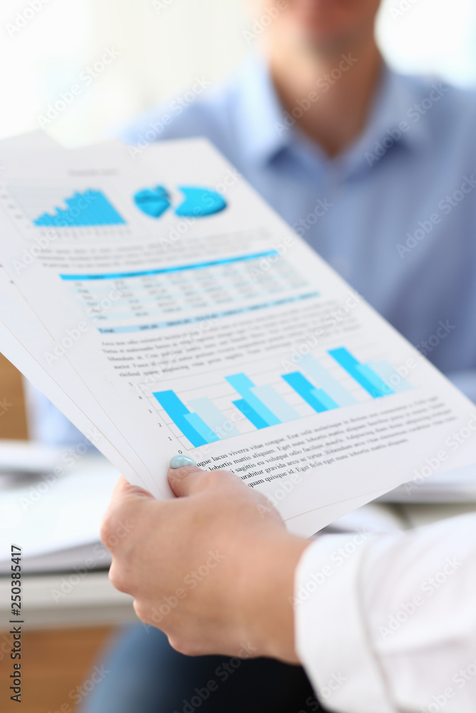 Group of people discuss financial results at workplace Group of people discuss financial results at workplace