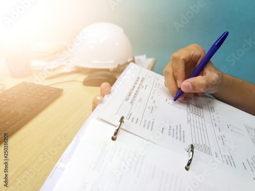Engineer inspecting and checking datasheet.Engineers check the preventive maintenance documents after the operation. 