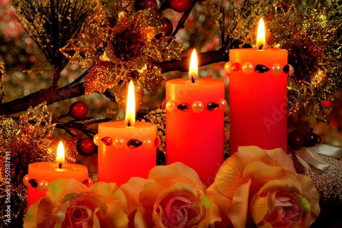 Bright candles  coniferous branch with toys and roses on the background of Christmas and new year lights. Winter holiday of Christmas  New year and significant events  fun and gifts.