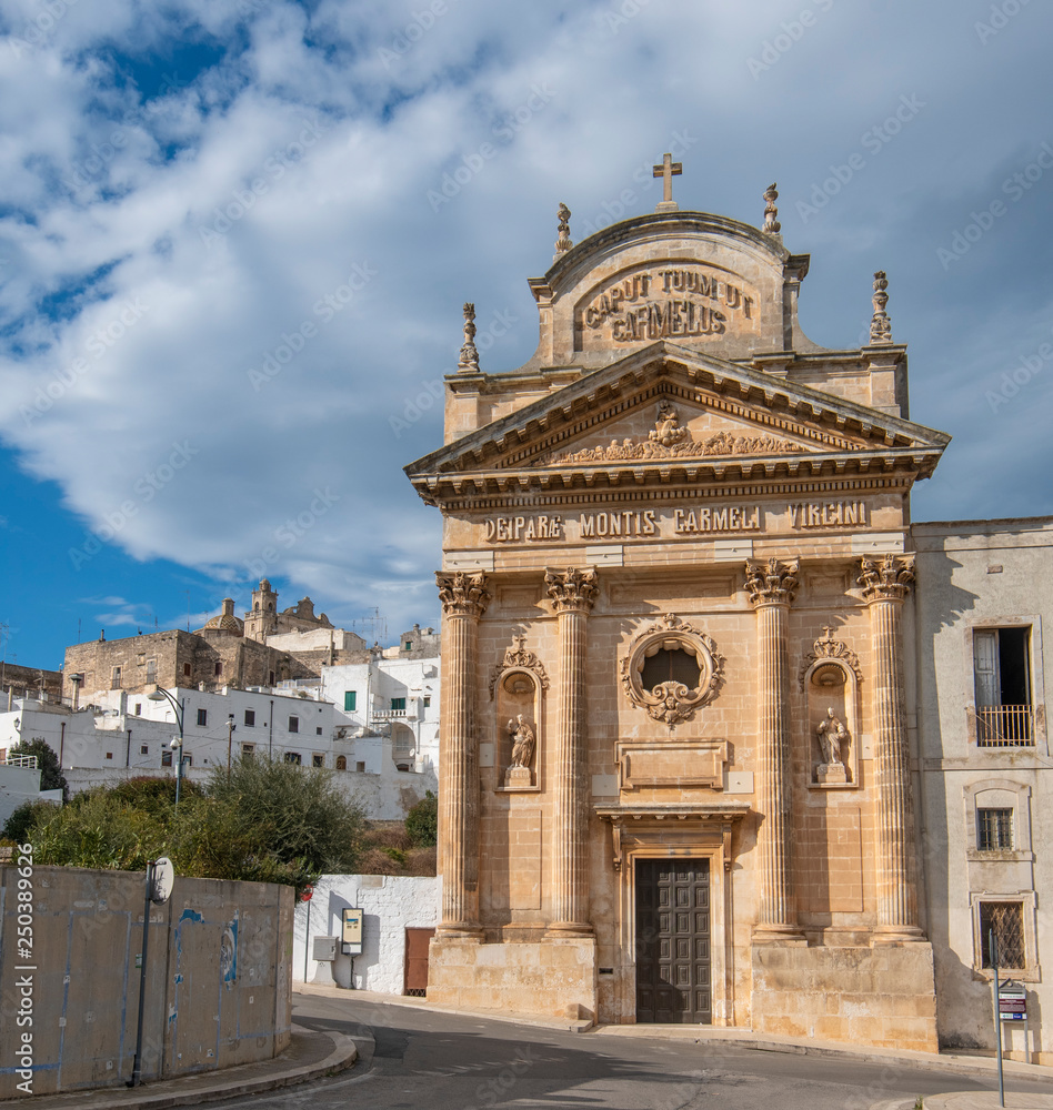 The picturesque old town and and Roman Catholic church Confraternity of Carmine. The white city in Apulia on the hill - Ostuni , Puglia, Italy