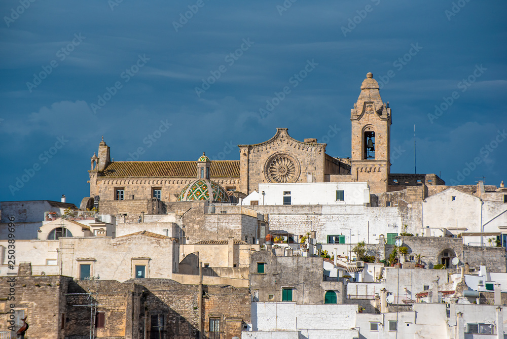 Panorama of The picturesque old town and Roman Catholic cathedral  - Assumption of the Virgin Mary (Concattedrale di Santa Maria Assunta). The white city in Apulia on the hill - Ostuni , Puglia, Italy