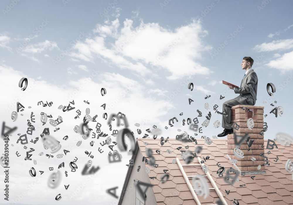 Man on brick roof reading book and symbols flying around Man on brick roof reading book and symbols flying around