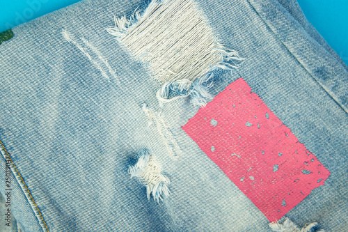 Jeans background with pink and blue destroyd denim photo