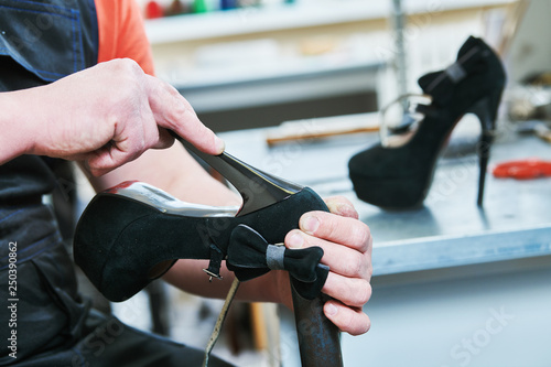 Shoemaker repair female spike shoe. glueing heel