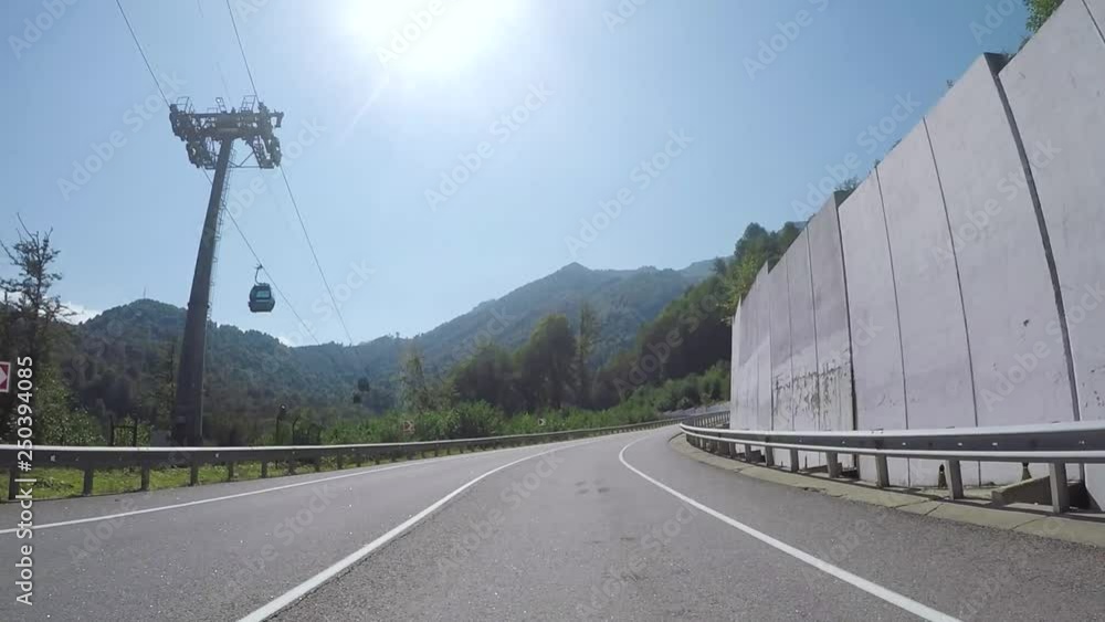 Moving forward motion of the car on serpentine highway, surrounded by