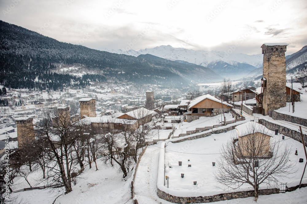 GEORGIA, SVANETI, MESTIA - JANUARY 30, 2019: View from above on the snow covered town with tower