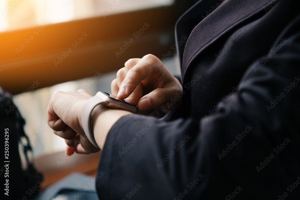 Fototapeta premium Businesswoman checking notifications on Smart Watch. Business and Technology concept.
