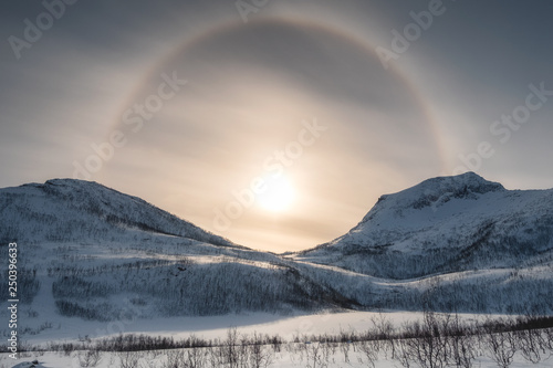 Snow mountain range with sun halo in winter