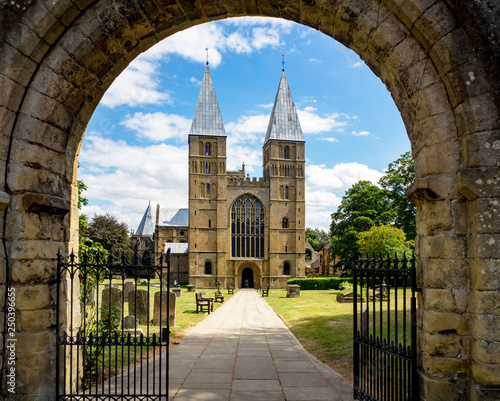 Southwell Mister and Romanesque Cathedral in Nottinghamshire, England, UK, viewed through the arcade of the main entry gate photo