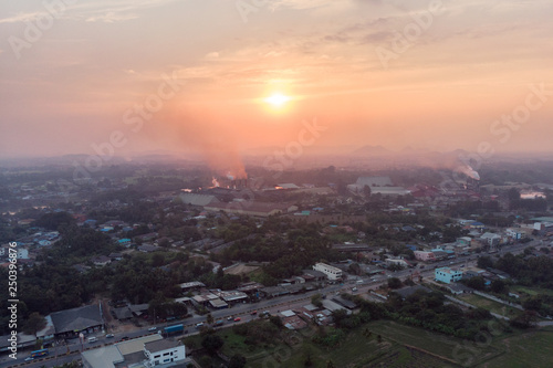 Aerial view of factory emission smoke into atmosphere in downtown