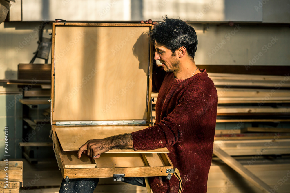Portrait of an artist who is making this easels in his studio. Portrait of an artist who is making this easels in his studio.