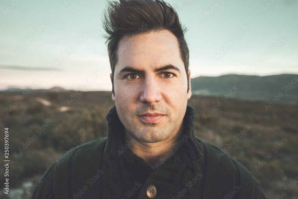 Portrait of a modern guy looking at the camera with happy expression on the outside. Portrait of a modern guy looking at the camera with happy expression on the outside.