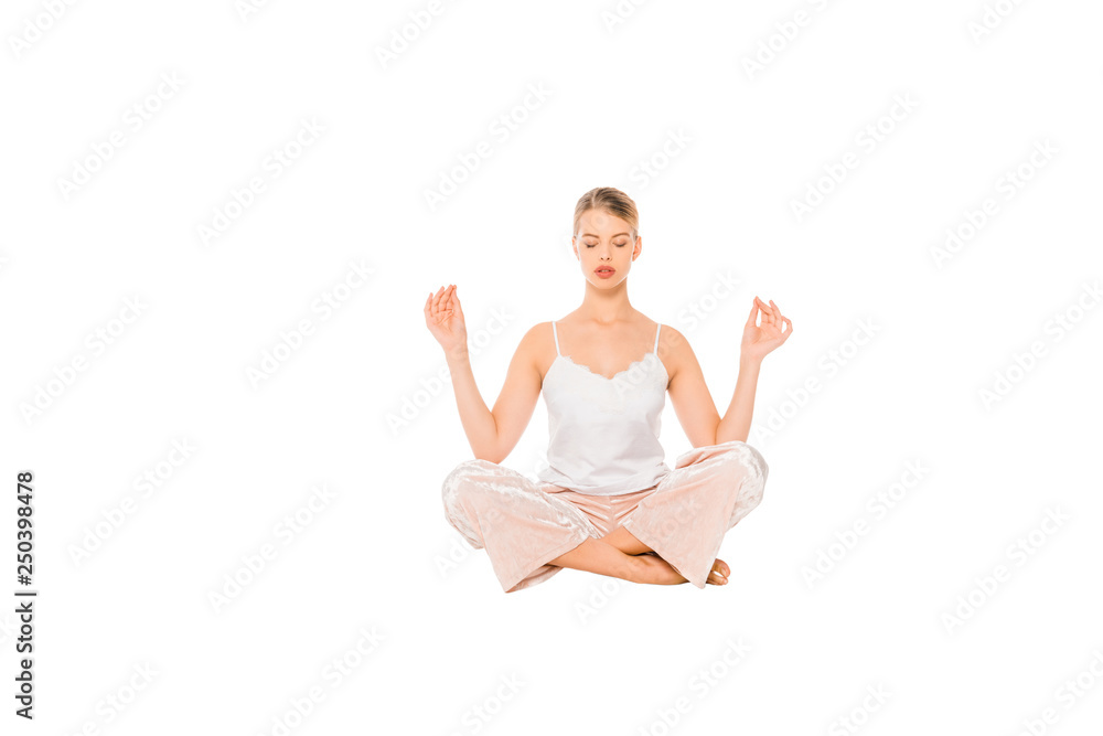 girl in pyjamas meditating in air isolated on white