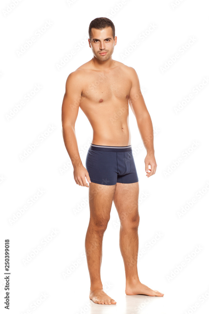 Shirtless handsome man in panties on white background