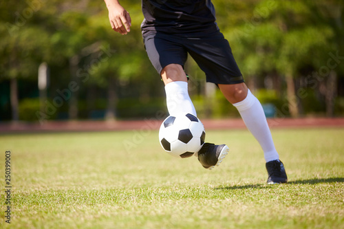 asian football player playing on field
