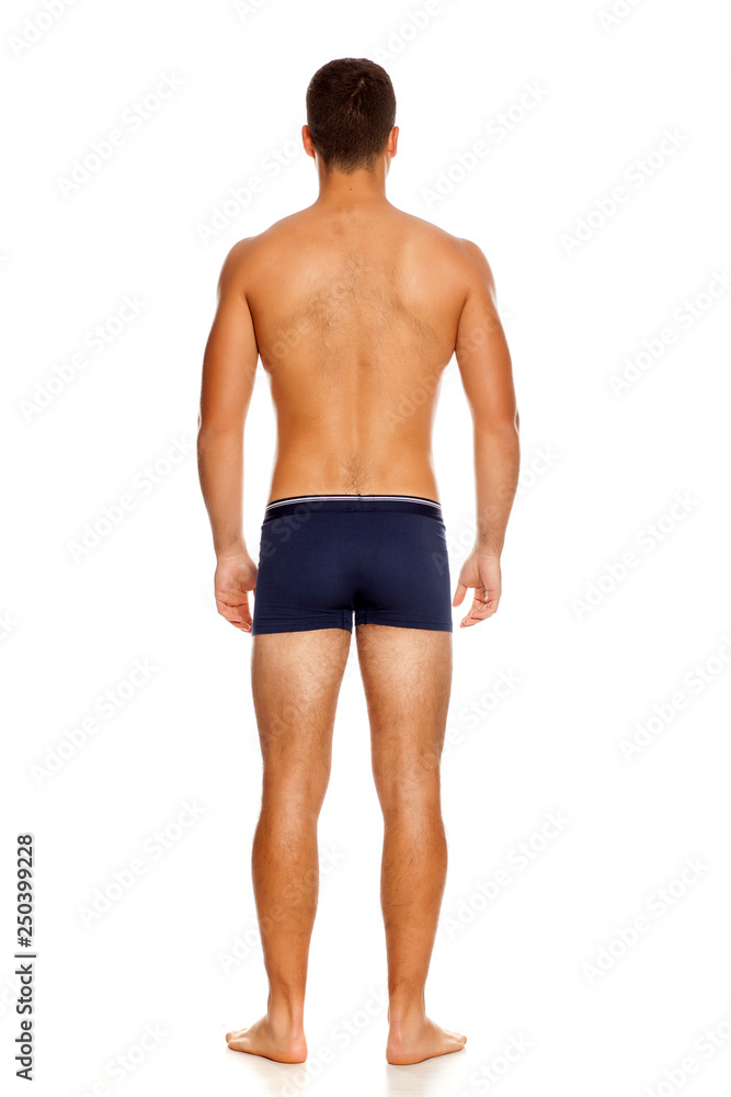 Back view of shirtless handsome man in panties on white background Back view of shirtless handsome man in panties on white background
