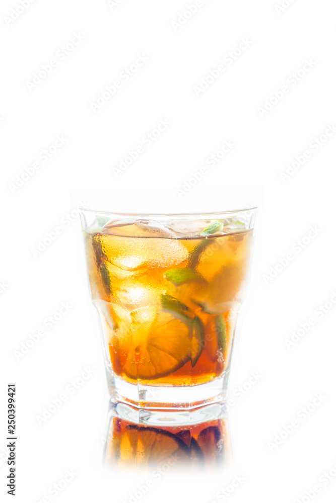 Cuba libre cocktail with cola and lime isolated on white background. Selective focus. Cuba libre cocktail with cola and lime isolated on white background. Selective focus.