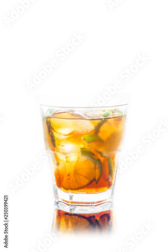 Cuba libre cocktail with cola and lime isolated on white background. Selective focus.