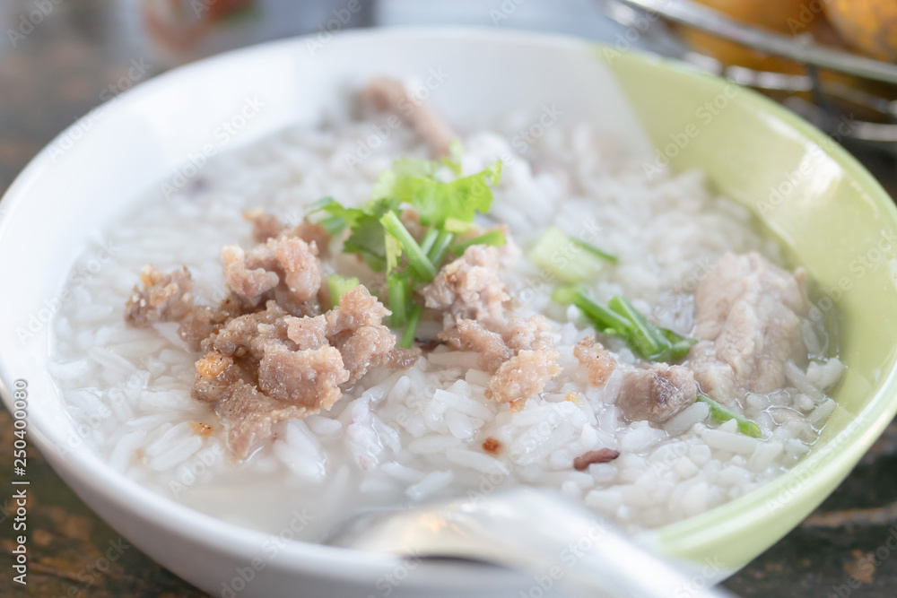 boiled rice with pork in a bowl on the wooden table boiled rice with pork in a bowl on the wooden table