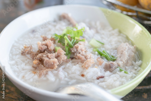 boiled rice with pork in a bowl on the wooden table