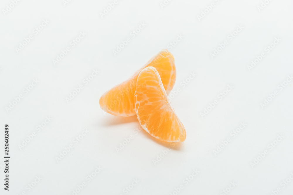 ripe bright orange tangerine slices on white background ripe bright orange tangerine slices on white background