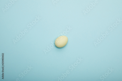 Top view of easter egg on blue background
