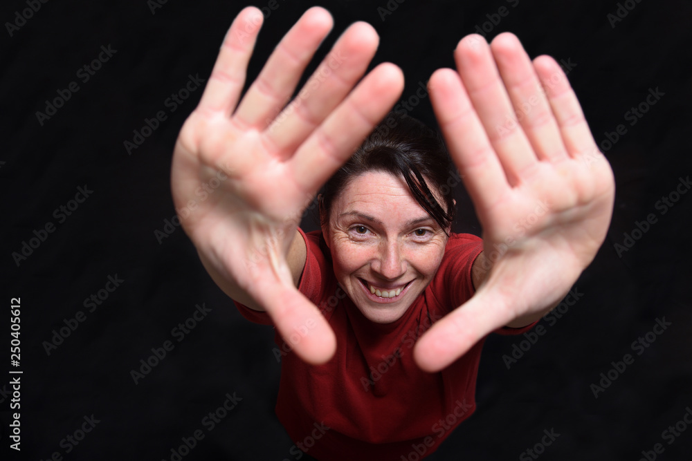 woman two hands up on black background woman two hands up on black background