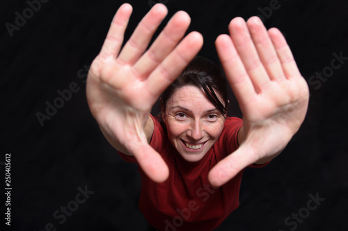 woman two hands up on black background