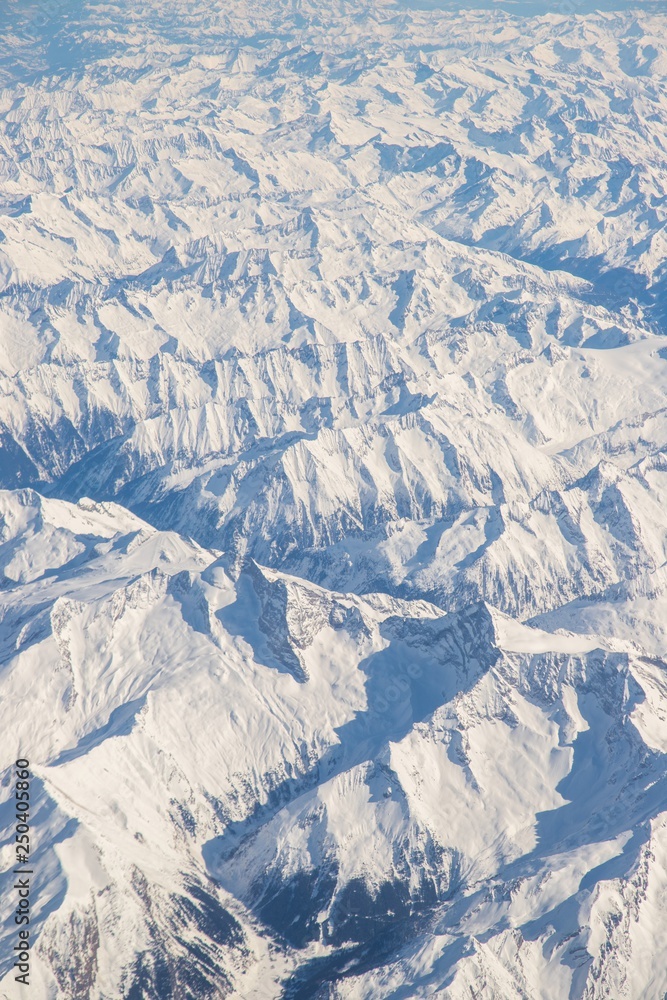 Aerial view of snow covered mountains - snowy mountain peaks - high mountains - Alps