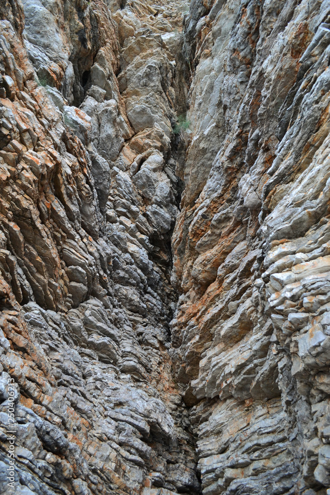 Beautiful landscape of rock canyon in Europe. Narrow ravine on sunny day. Beauty of nature. Stone cliff on the sea beach. Process of sightseeing in summer. Beautiful landscape of rock canyon in Europe. Narrow ravine on sunny day. Beauty of nature. Stone cliff on the sea beach. Process of sightseeing in summer.